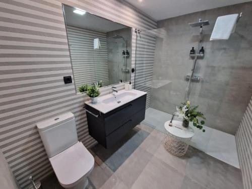 a bathroom with a sink and a toilet and a shower at Aurora in Ávila