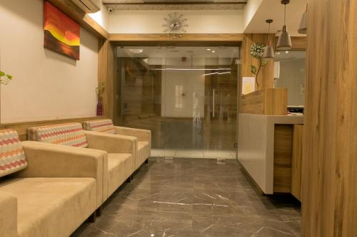 a living room with two couches and a lobby at HOTEL HIRISA Unit Of Hotel Fortune Palace in Jamnagar