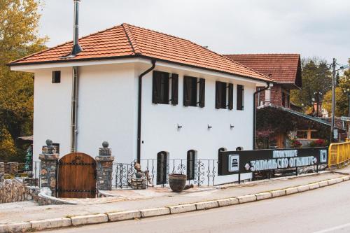 a white house with a red roof at Konačište Zaplanjsko ognjište 