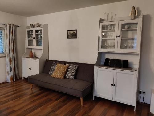 a living room with a couch and white cabinets at Ferienhaus Am Bach in Kirchberg an der Raab