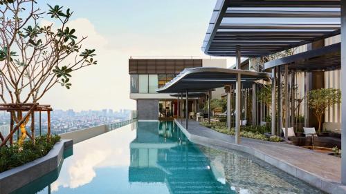 a swimming pool on the roof of a building at N Condominium in Ban Bang Khen (1)