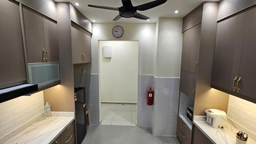 a bathroom with a ceiling fan and a clock on the wall at SYG12 Homestay Dalur Presint 18 in Putrajaya