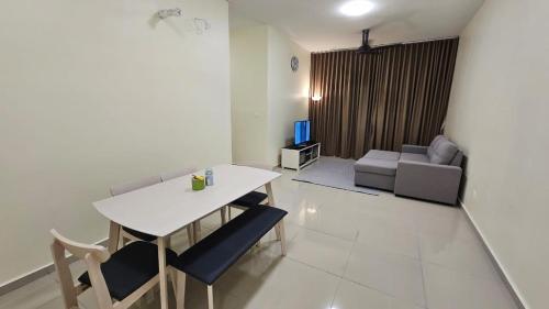 a living room with a table and chairs and a couch at SYG12 Homestay Dalur Presint 18 in Putrajaya