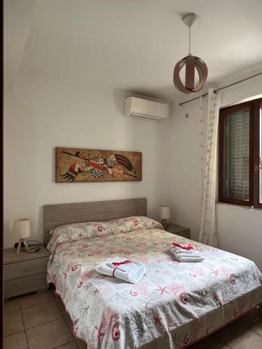 a bedroom with a bed with two towels on it at Sweet Home La Ville in Caserta