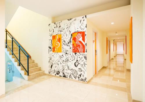a hallway of a house with a painting on the wall at Front One Inn Muntilan in Muntilan