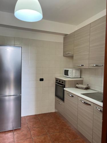 a kitchen with a stainless steel refrigerator and appliances at Sweet Home La Ville in Caserta