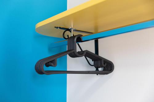 a surfboard hanging from a rack on a wall at 16TH FAD ROOMS in Margherita di Savoia