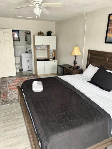 a bedroom with a large bed with a black blanket at California King Cozy Comfort in Pahokee