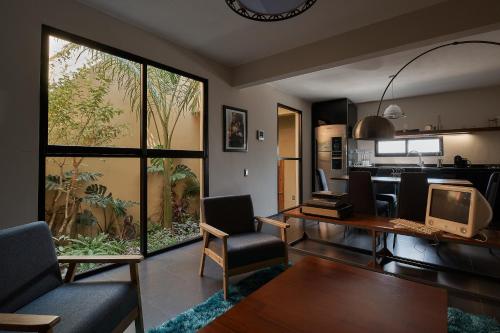 a living room with a desk with a computer on it at Las Privadas / Casa X By Nardazul in Oaxaca City