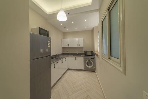 a kitchen with a washer and a washing machine in it at Luxurious One-Bedroom Suite Pyramids Giza in Giza