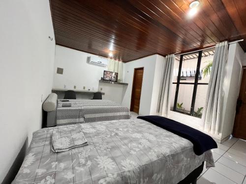 a bedroom with two beds and a large window at AL EVENTOS in Teresina