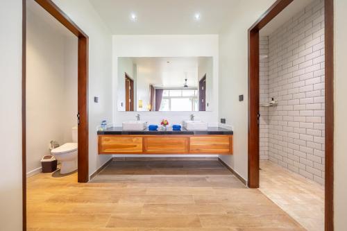 La salle de bains est pourvue d'un lavabo et d'un miroir. dans l'établissement The Cokelat Amed, à Amed