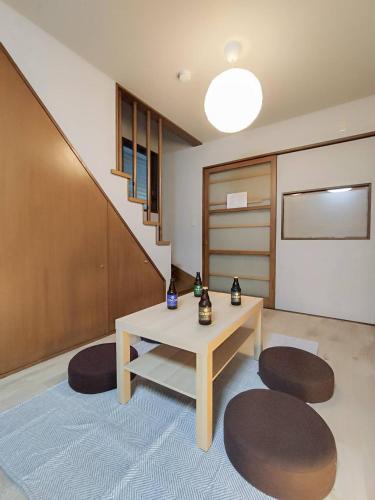 a room with a table and two chairs and a staircase at R House 川越 in Kawagoe