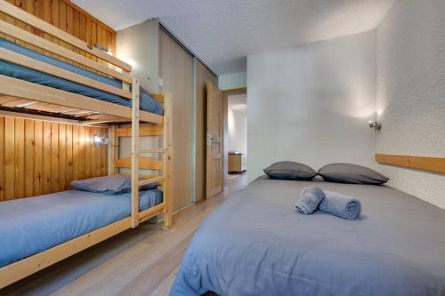 a bedroom with two bunk beds with blue pillows at FRANCHET B 34 in La Daille