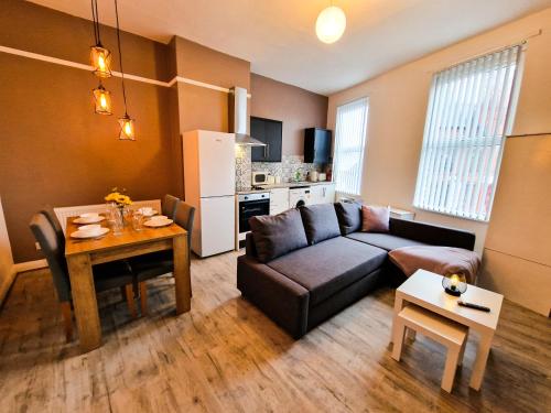 a living room with a couch and a table at Nice and comfy 1 bedroom apartment! in Liverpool