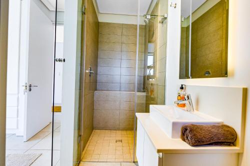 a bathroom with a sink and a shower at Oceans Edge 3, Zimbali Estate in Ballito
