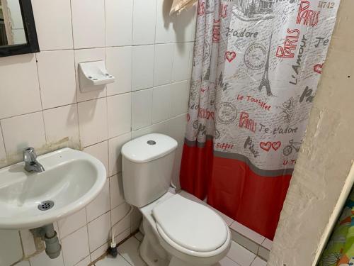 a bathroom with a toilet and a sink at Habitación independiente cerca al mar. in Puerto Salgar