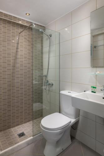 a bathroom with a toilet and a shower and a sink at Nafsika Hotel in Rhodes Town