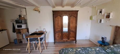 um quarto com uma porta, uma mesa e uma cozinha em L'Echappée Belle - Centre ville - vue cour arborée em Bourg-en-Bresse