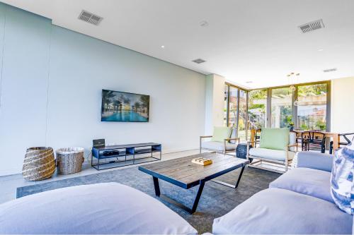 a living room with a couch and a table at Oceans Edge 3, Zimbali Estate in Ballito