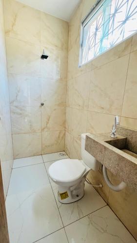 a bathroom with a toilet and a shower at Oásis da Praia in Caucaia