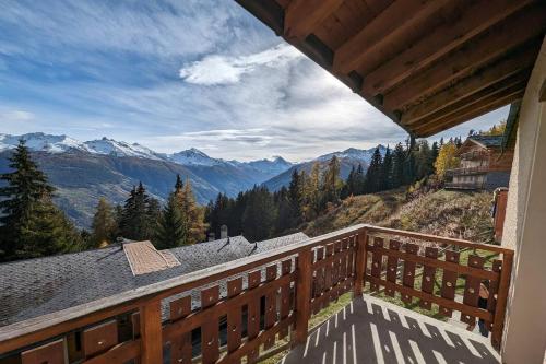 a balcony of a house with a view of mountains at Chalet Cactus - 4 Vallées in Hérémence