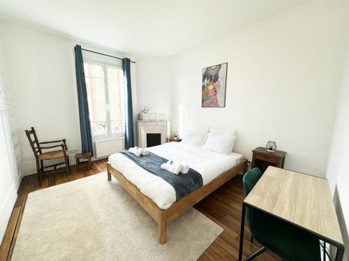 une chambre avec un lit, une table et une chaise dans l'établissement Le Patio - Joli logement - Wifi - Disney & Paris, à Champigny-sur-Marne