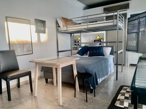 a bedroom with a bed and a table and a bunk bed at Perfect location for the Olympic stadium Would sleep 4 comfortably for an overnight stay in Athens