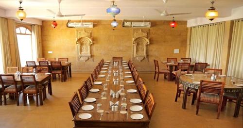 a large dining room with tables and chairs at Sam Sand Dunes Jaisalmer in Jaisalmer