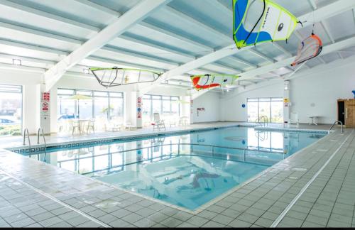 a large swimming pool with blue water at 39 Woodland Walk in Pevensey