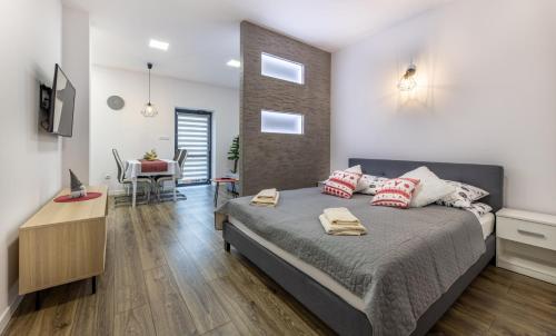 a bedroom with a bed and a dining room at Apartamenty Bełska Centrum in Ustrzyki Dolne