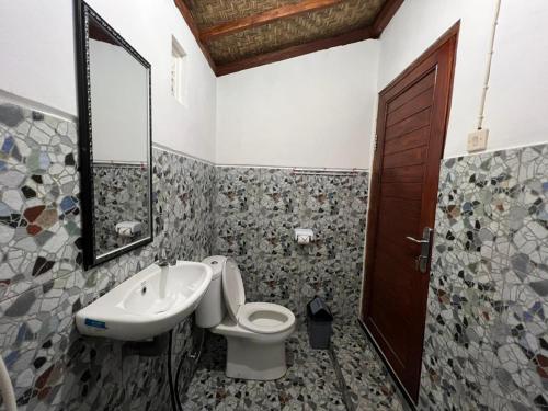 a bathroom with a toilet and a sink at Bali Cottages Lake View in Kintamani