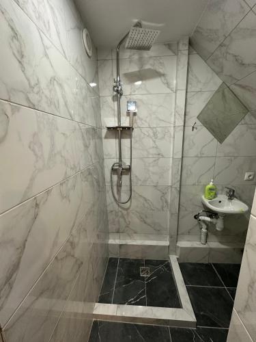 a bathroom with a shower and a sink at House Menchul in Mala Uhol'ka