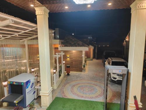 a view of a house with columns and a green carpet at ARCO Hotels and Resorts Srinagar in Srinagar