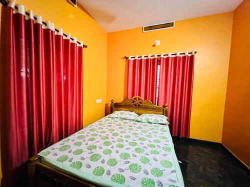 - une chambre dotée de rideaux rouges et d'un lit dans l'établissement Paddy View Service Villa, à Wayanad