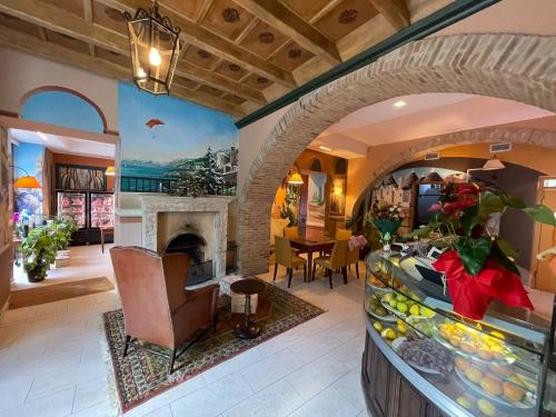 a lobby of a hotel with a counter and a room at Hotel 99 Cannelle in LʼAquila