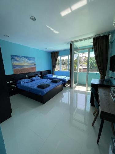 a large bedroom with two beds and a desk at GazStation in Kata Beach