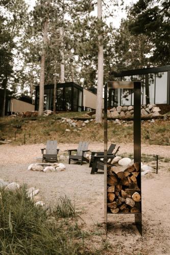 a group of benches and a pile of fire wood at Nature Link Resorts in Nisswa