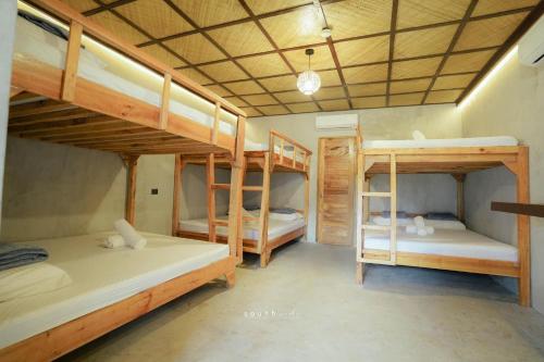 a room with three bunk beds in it at Marika Resort in Badian