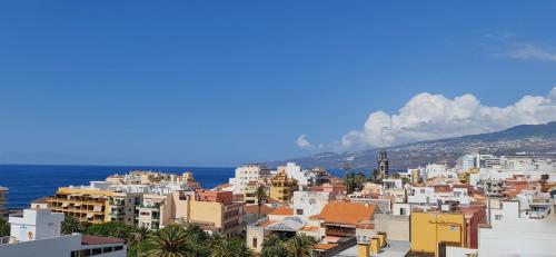 a view of a city with buildings and the ocean at Appartement Girasol Puerto de la Cruz, plaza Charco in Puerto de la Cruz