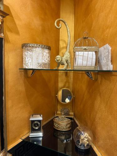 a shelf with a bird cage and other items on it at Le Stanze del Principe in Genova