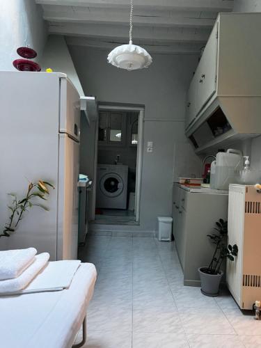 a kitchen with a refrigerator and a washing machine at Kioura's home in Ano Syros
