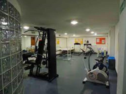a gym with several tread machines in a room at Cervinia in residence in Breuil-Cervinia