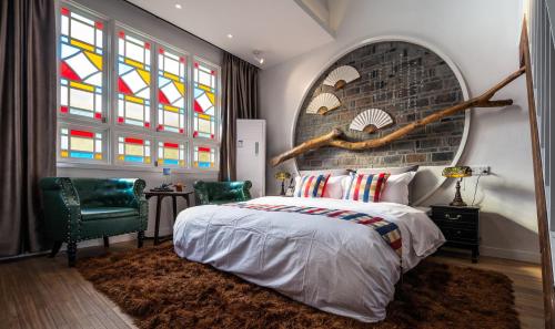 a bedroom with a bed and stained glass windows at Suzhou Houlishenghuo Guesthouse in Suzhou