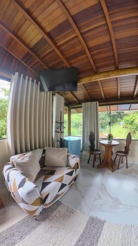 a living room with a couch and a table at Diver Village Ilhabela in Ilhabela