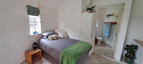 a small bedroom with a bed and a window at The Centre Circle in Hilton