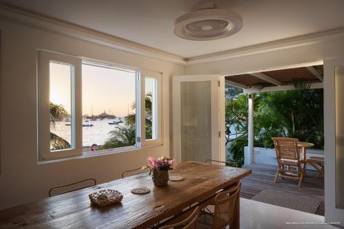 a dining room with a table and a view of the ocean at On the Beach , in Saint Barth... Mellow Mood Villa in Saint Barthelemy
