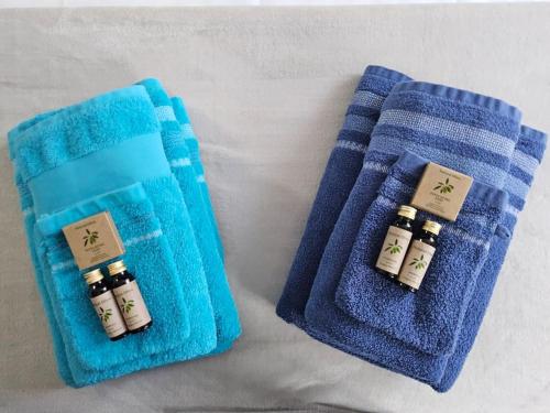 two pieces of blue towels sitting next to each other at La maison des galeries classé 4 étoiles in Fécamp