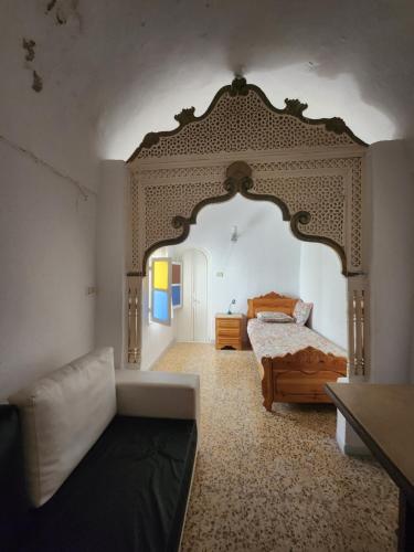 a bedroom with a large bed and a couch at Villa Hammamet in Hammamet
