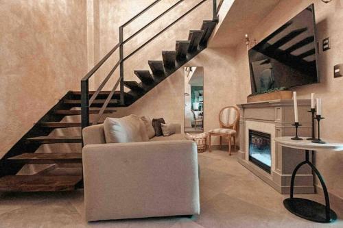 a living room with a staircase and a couch and a fireplace at TRASTEVERE in Tlaxcala de Xicohténcatl
